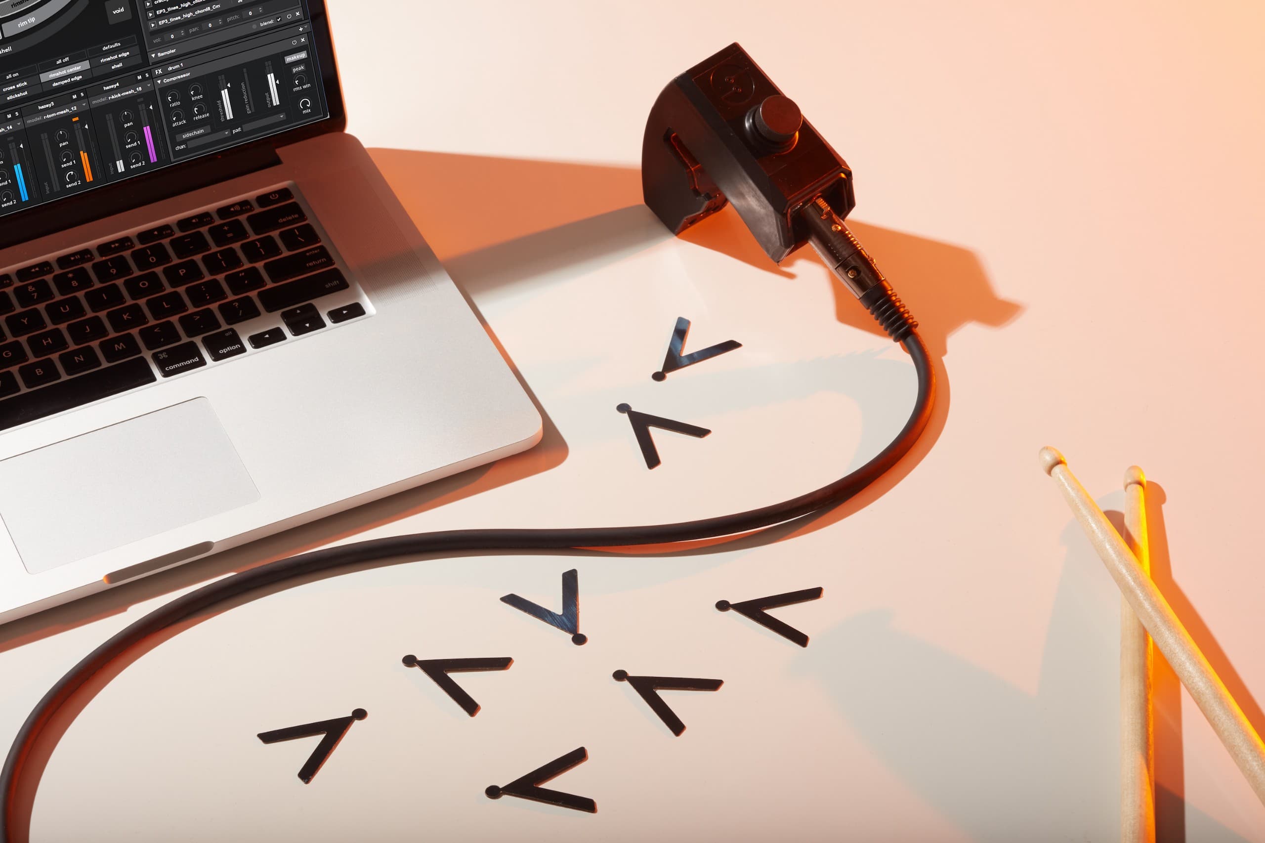 A photo of a laptop with a sensor on a table