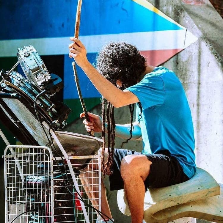 A photo of Travis playing drums on the street