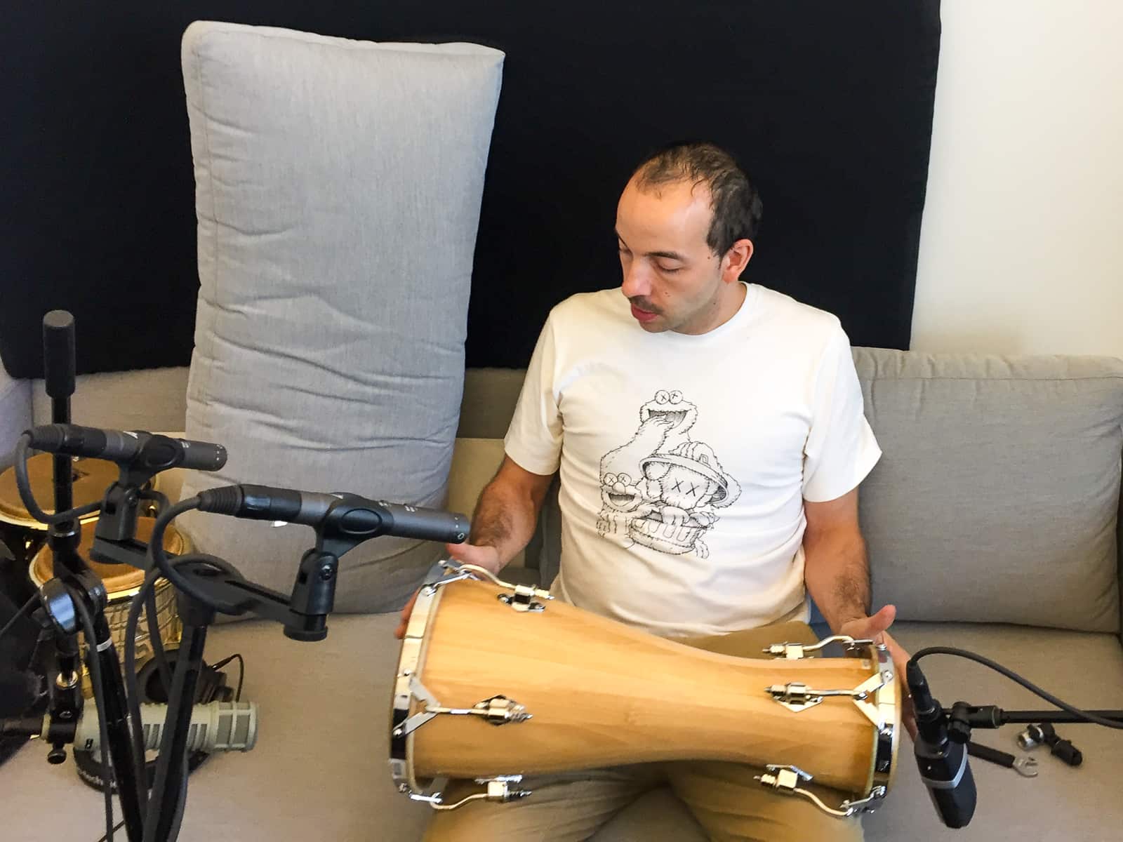 Amaury Acosta holding bata next to microphone