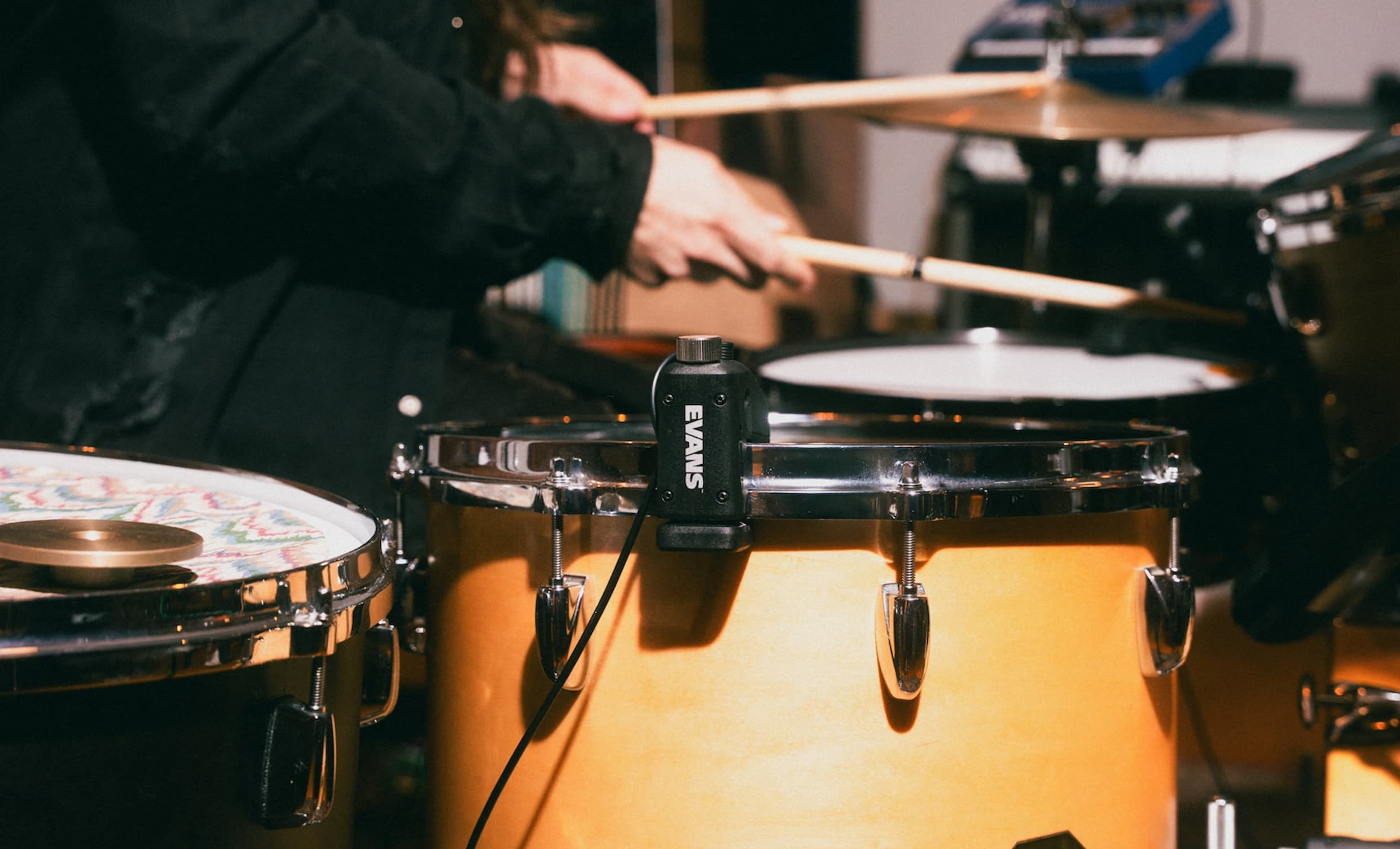 A drummer playing a tom fitted with a Sensory Percussion sensor