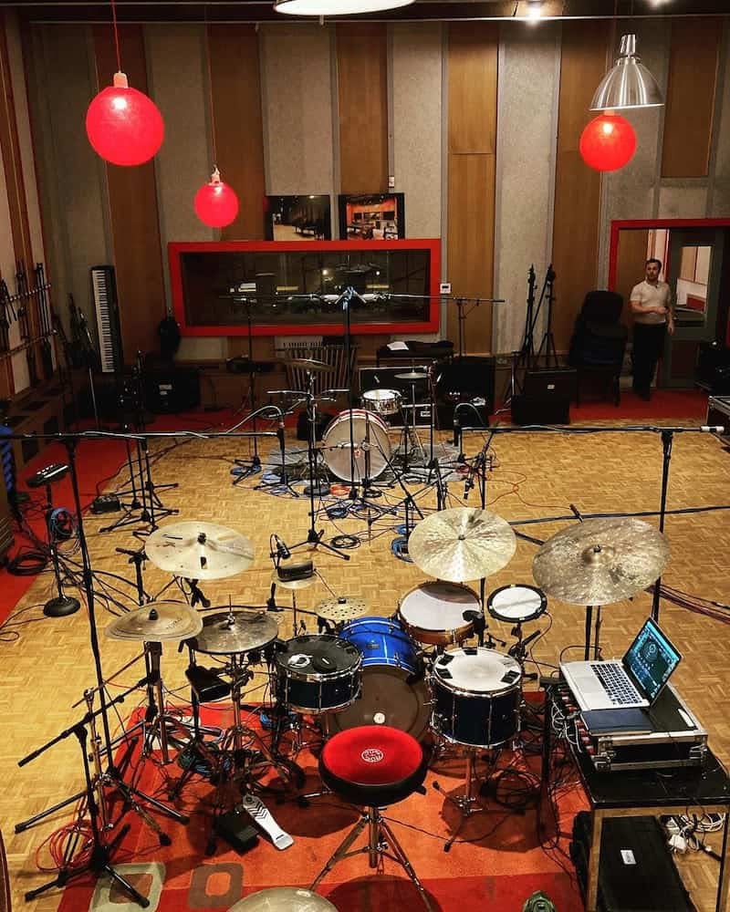 An overhead shot showing a large studio with two drum sets set up facing each other from across the studio, the closer one using Sensory Percussion