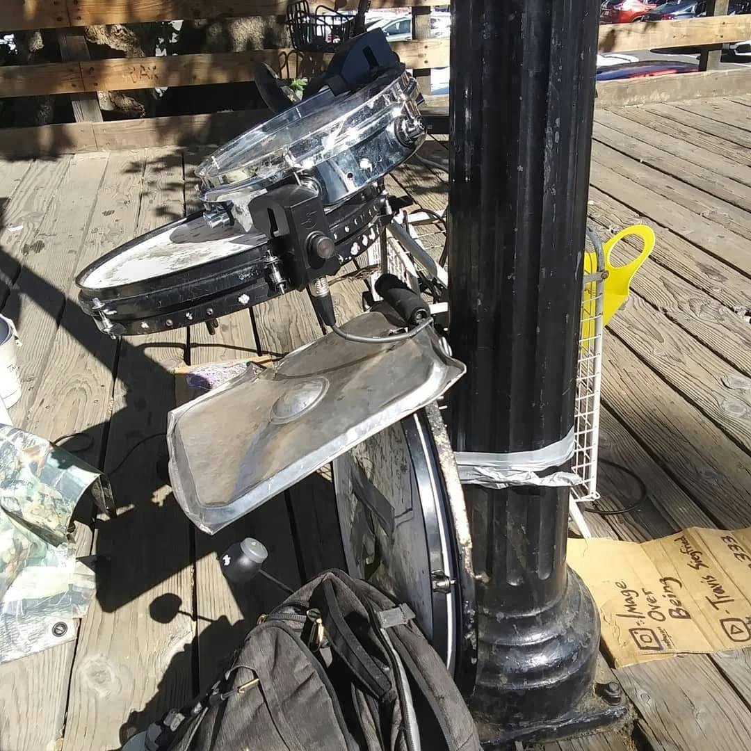 A photo of one of Travis' unique setups featuring two sensors, a pancake kick, and a metal sheet tied to a lamppost on the street