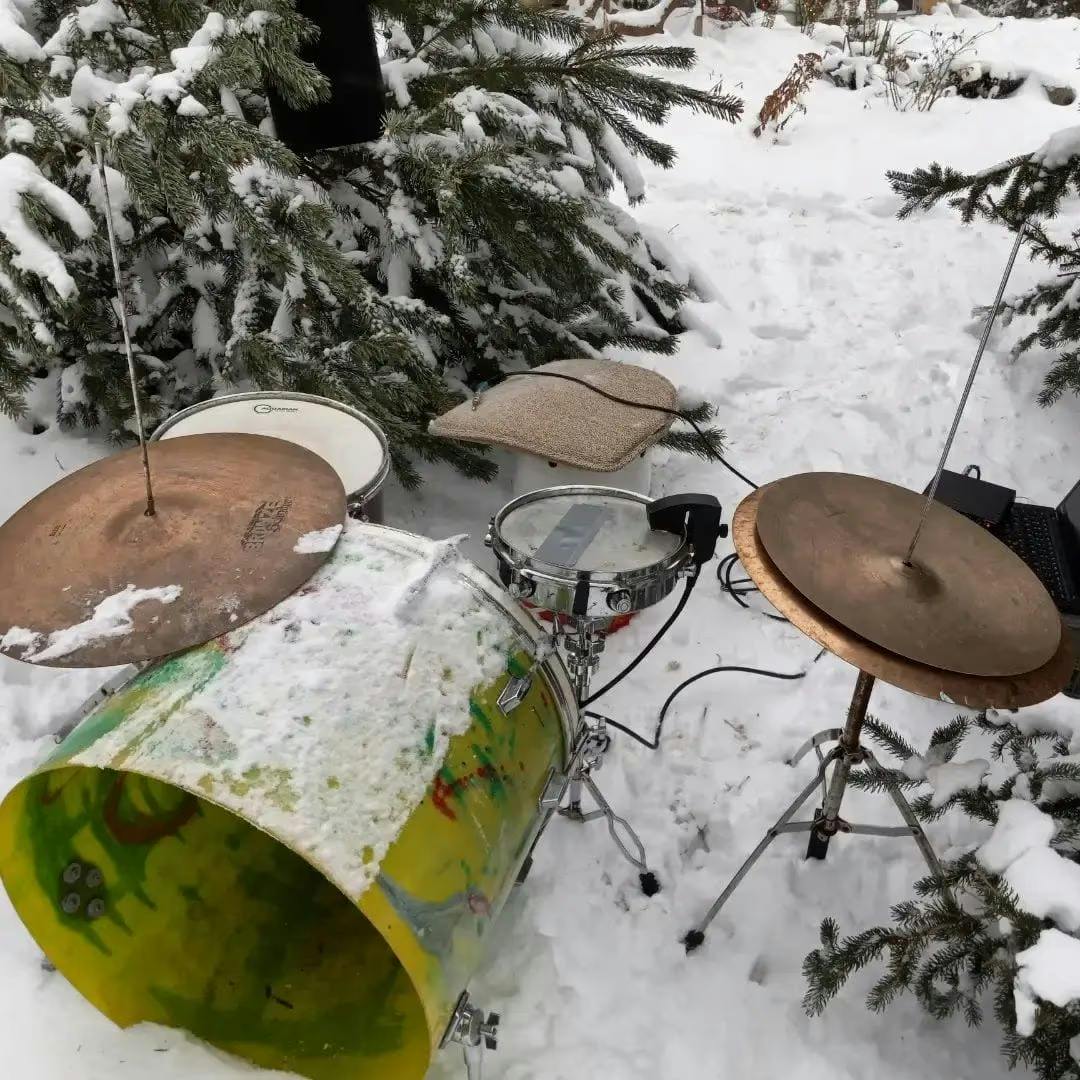 A photo of a drum kit outside in the snow with a Sensory Percussion sensor on the snare.