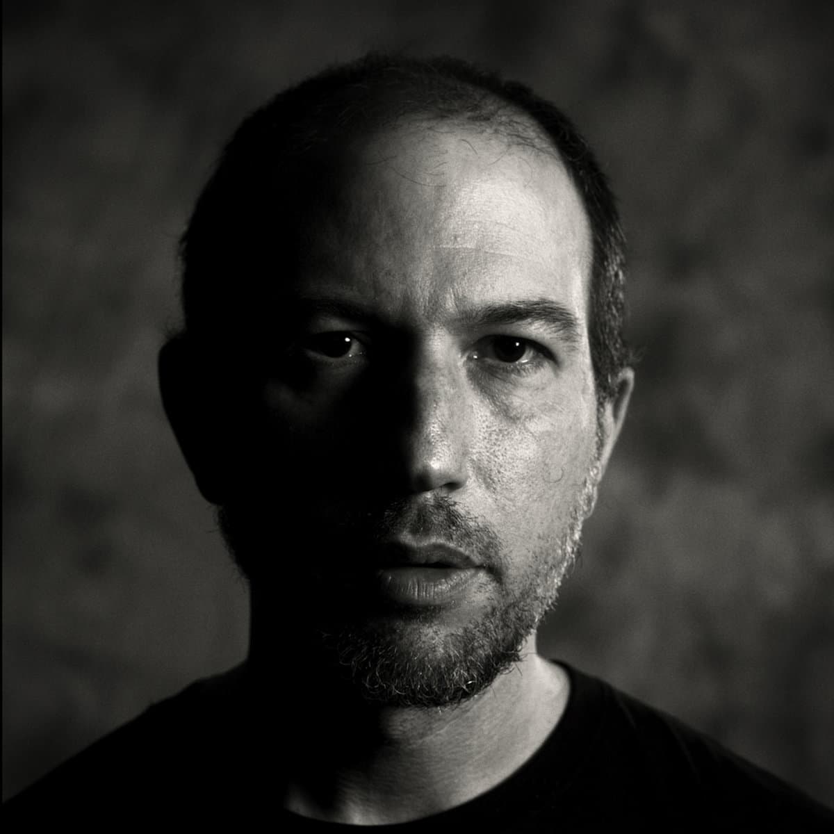 A black-and-white-photo of a man, Eliot Krimsky, looking straight ahead