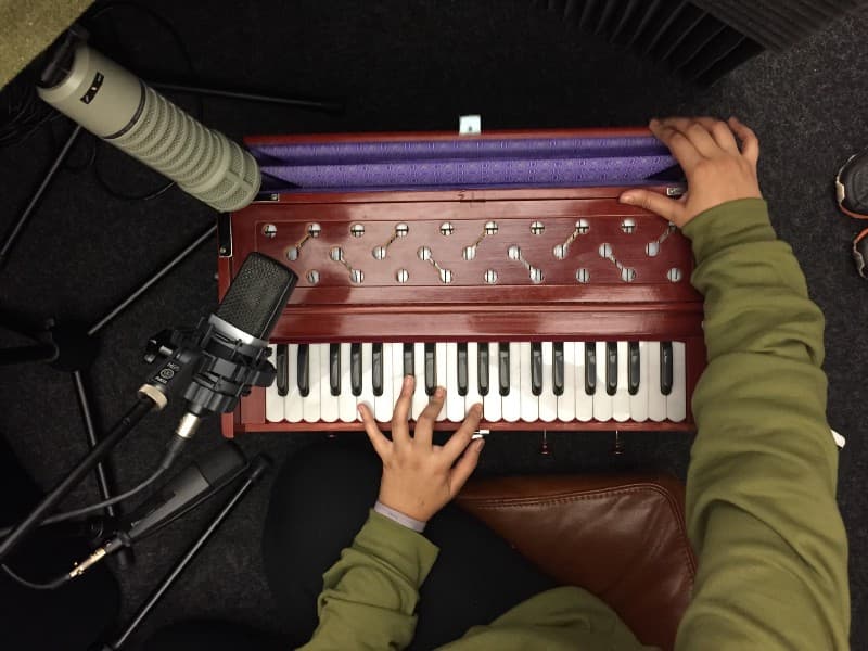 A photo of Mahin sampling the harmonium we used in the Ganzfeld soundpack