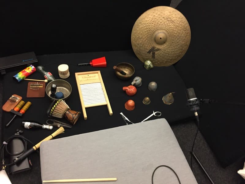A photo of a collection of various percussion instruments and toys