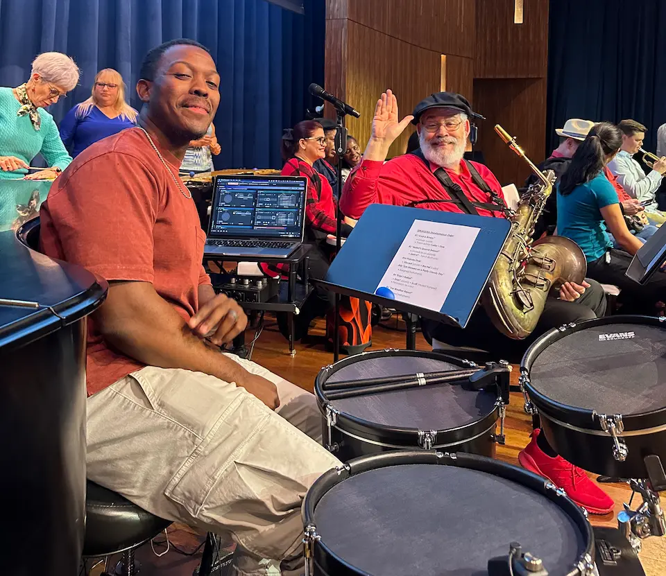Gerald Law sitting at his drums set smiling at the camera