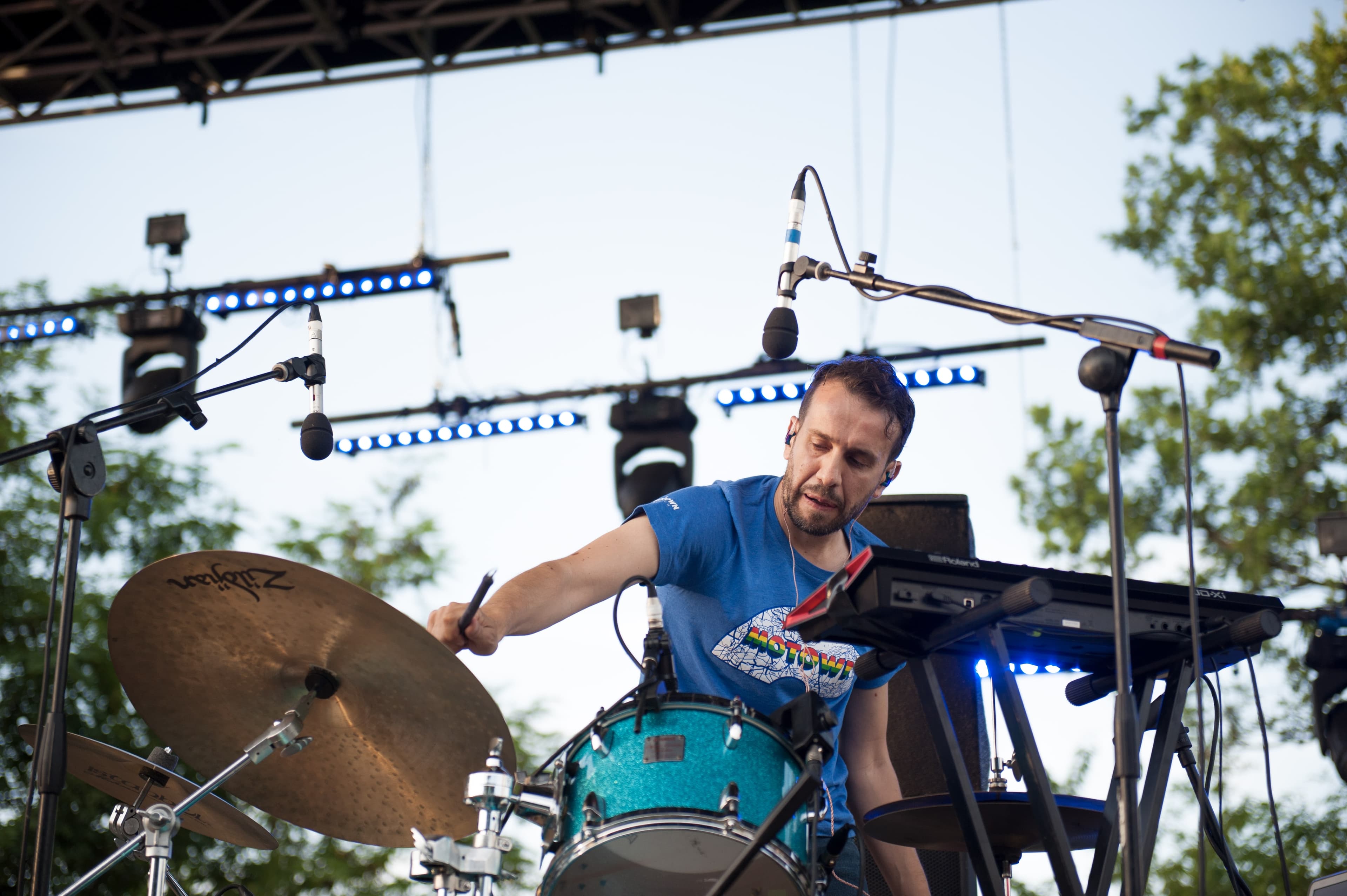 Tommaso performing a hybrid Sensory Percussion-Acoustic kit there is a keyboard synth visible, as well
