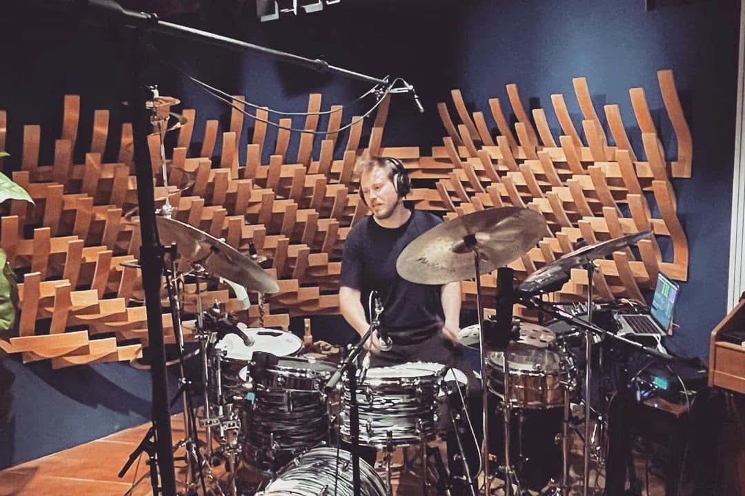 A photo of Wout playing behind the kit taken facing the drums