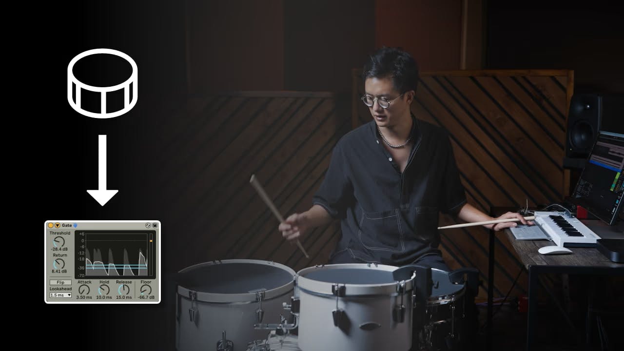 A photo of Ian Chang playing Sensory Percussion with one hand and using his computer keyboard with his other hand.