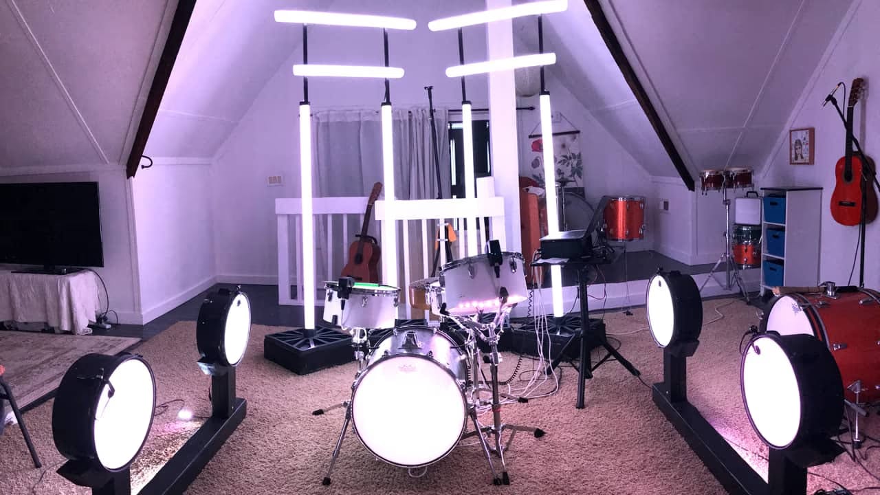 A photo of a drum set and an elaborate lighting rig