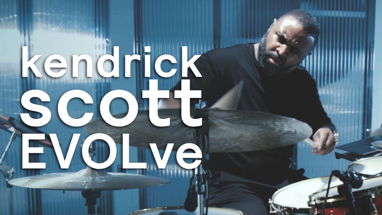 A photo of Kendrick Scott playing drums with Sensory Percussion