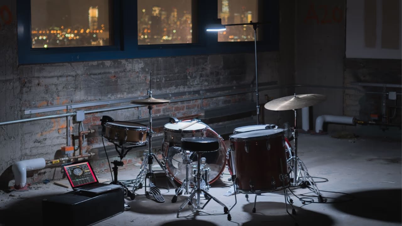 A photo of a drumset in a moody room.