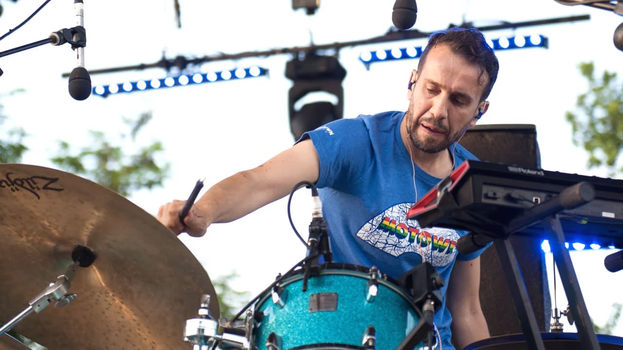 A photo of Tommaso Cappellato on stage playing a Sensory Percussion hybrid kit